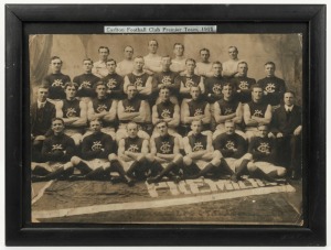 Large format original photograph with title above "Carlton Football Club Premier Team, 1915" with the team and officials seated behind the premiership pennant on the floor in front of them. Framed overall 32 x 42cm.