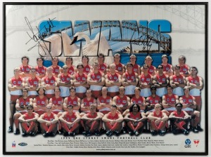 SYDNEY SWANS: Complete team list photograph with a back drop of Sydney Harbour, signed by Tony Lockett and Paul Kelly. Framed and glazed 48 x 64cm overall.