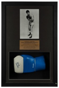 Johnny Famechon signed glove, attractively presented in a box frame with a black & white publicity photograph and an engraved plaque describing his career which included becoming the World Featherweight Champion in January 1969. With CofA. Overall 71 x 46cm.
