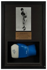 Johnny Famechon signed glove, attractively presented in a box frame with a black & white publicity photograph and an engraved plaque describing his career which included becoming the World Featherweight Champion in January 1969. With CofA. Overall 71 x 46