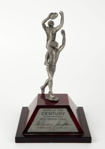 Jesaulenko's 1970 Grand Final "Mark of the Century" immortalized in a limited edition statuette with plaque on front and plaque bearing statement of limitation [119/1000] on the back; raised on a timber plinth; overall 24cm high. (NB: We have seen only on
