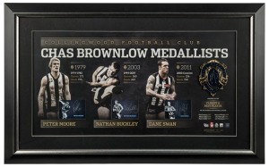 Collingwood FC signed Brownlow official print with replica Brownlow Medal. Limited edition #21 of 200. Signed by Peter Moore, Nathan Buckley and Dane Swan. Official AFLPA CoA included. 53 x 85cm overall