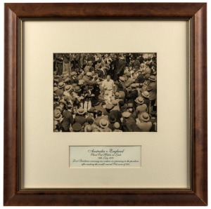 12th JULY 1930, original press photo showing Don Bradman receiving an ovation on returning to The Pavilion after making the world's record Test score of 334. Signed in pen (faded), 18 x 24cm, attractively framed and glazed 46 x 46cm overall