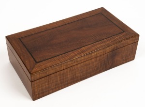 An antique Australian fiddleback blackwood jewellery casket with ebony string inlay and cedar secondary timbers, interior lined with original blue velvet, early 20th century, 7cm high, 25.5cm wide, 13.5cm deep