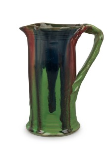 REMUED pottery jug with early shape and glaze in lime green, pink and blue, incised "Remued", 18.5cm high