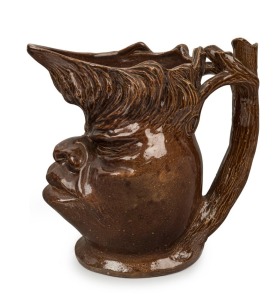 WILLIAM RICKETTS early brown glazed pottery face jug with branch handle, incised "Wm. RICKETTS, 1934", 15.5cm high, 15.5cm wide