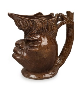 WILLIAM RICKETTS early brown glazed pottery face jug with branch handle, incised "Wm. RICKETTS, 1934", ​​​​​​​15.5cm high, 15.5cm wide