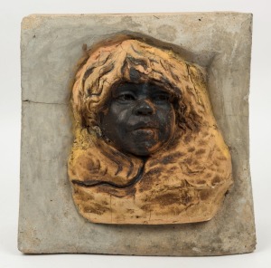 WILLIAM RICKETTS pottery Aboriginal face plaque, mounted in later concrete surround for garden mounting, 26cm high, 34cm high overall