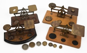 Four antique and vintage postal scales with assorted brass weights, 19th/20th century, ​​​​​​​the largest 21cm wide