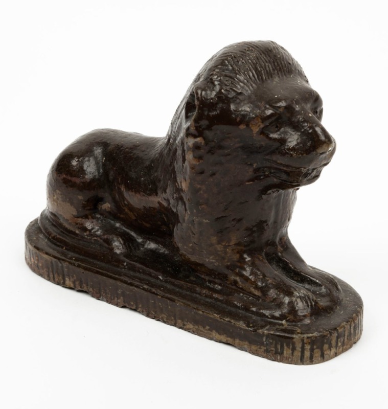 An antique Australian pottery lion doorstop, 19th century, ​​​​​​​incised "L.B.", 15cm high, 22.5cm long