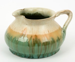 REMUED green and cream glazed pottery jug with branch handle, incised "Remued 173L", 10cm high, 18cm wide