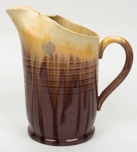 REMUED pottery jug with mauve and cream glaze,  incised "Remued 72", bearing original foil label,  22.5cm high 