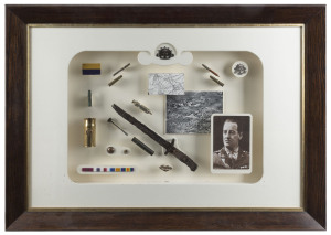An ALBERT JACKA, VC TRIBUTE An attractively mounted and framed display of army badges, ribbons and buttons combined with battlefield finds - bullet cases, a bayonet, trench art and a 9ct gold and pearl "MOTHER/A.I.F." boomerang brooch, together with a pho