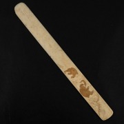 An antique Japanese ivory page turner, carved with monkeys in landscape, Meiji Period, 19th century, 30cm long