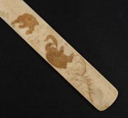 An antique Japanese ivory page turner, carved with monkeys in landscape, Meiji Period, 19th century, 30cm long - 2