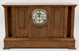 An Australian fiddleback blackwood and maple cased antique clock, Ansonia time and strike movement with open escapement and Roman numerals, 19th/20th century, ​​​​​​​34cm high, 54cm wide