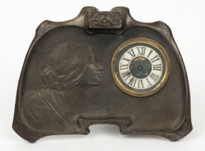 An American Art Nouveau table clock in white metal case with female profile portrait, timepiece only with Roman numerals, circa 1900, 15cm high, 22cm wide