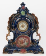 An antique German porcelain cased mantle clock, time piece only, early 20th century, 45cm high