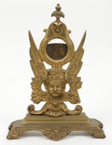 An antique cast metal pocket watch stand with gilt finish, 19th century, 25cm high