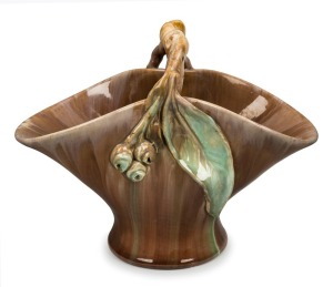 REMUED green and brown glazed basket vase with applied gumnuts and leaf with branch handle, incised "Remued 194/10M", 20cm high x 26cm wide