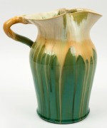 REMUED&nbsp;green and cream glazed pottery jug with applied branch handle, gumnuts and leaf, incised "Remued 54/8M", 25cm high - 2