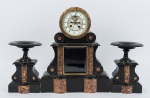 An antique French drumhead mantle clock in Belgium black slate and variegated marble case accompanied by matching garnitures, eight day time and strike movement, temperature compensated pendulum, open escapement and Roman numerals, 19th century, 47cm high