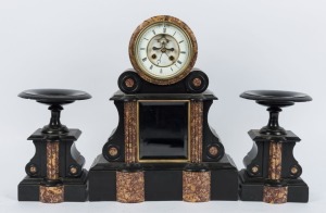 An antique French drumhead mantle clock in Belgium black slate and variegated marble case accompanied by matching garnitures, eight day time and strike movement, temperature compensated pendulum, open escapement and Roman numerals, 19th century, 47cm high