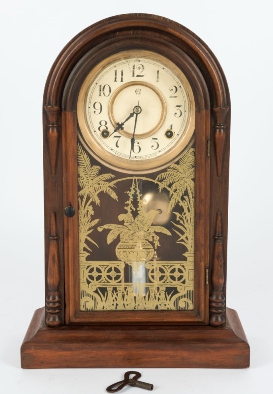 WATERBURY antique American dome top mantle clock in rosewood case, eight day time and strike movement with Arabic numerals, 19th century, 44cm high