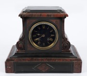 An antique French mantle clock in red marble and slate case, eight day time and strike movement with Roman numerals on black dial, 19th century, 24cm high