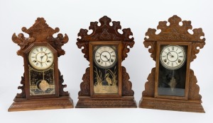 Three antique American cottage clocks in pressed timber cases, 19th century, the largest 57cm high