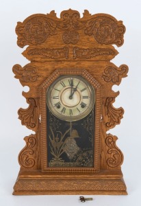 WELCH antique American cottage clock in pressed oak case with eight day time and gong striking movement, 19th century, 61cm high