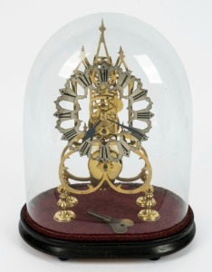An antique English skeleton clock with scroll frame, eight day time only fusee movement with silvered fretted chapter ring, all housed in original glass dome, 19th century, 38cm high overall