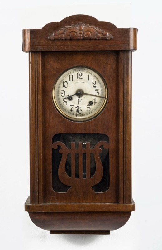 An antique German musical alarm wall clock in timber case. Thirty hour movement with six musical disc, early 20th century, ​​​​​​​49cm high