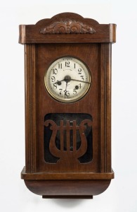 An antique German musical alarm wall clock in timber case. Thirty hour movement with six musical disc, early 20th century, 49cm high
