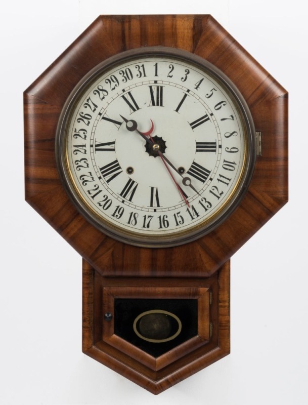 An antique American wall clock in walnut case, eight day time and strike movement with calendar dial, 19th century, 65cm high