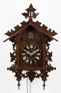 An antique timber cased cuckoo clock with Roman numerals and parquetry decoration, 19th century, 54cm high