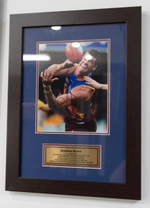 BRISBANE LIONS: Jonathan Brown signed photo (framed 50 x 38cm) together with a Daniel Rich signed photo (framed 89 x 56cm); both with ASM Certificates of Authenticity. (2 items).