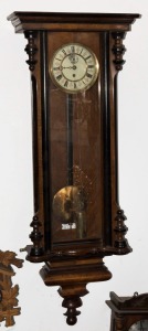 A Vienna regulator wall clock in walnut and ebonised timber case, single weight movement with enamel dial and Roman numerals, 19th century, 116cm high