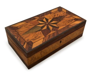 JOHN WILSON CAREY stunning Queensland specimen wood writing box with fitted interior, handsomely inlaid with starburst top in tulip wood, water gum, scrub ebony, breadfruit tree, forest oak, deep yellow wood, pale yellow wood, cypress pine, scented myall, Morton Bay pine and beech, with Australian cedar secondary timbers, circa 1870. Accompanied by a hand-written key with timber details, plus a further hand-written note "Made And Exhibited By JOHN WILSON CAREY, William St. Brisbane".