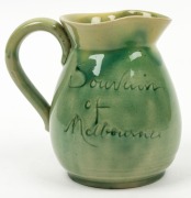 REMUED&nbsp;"Fawkner&nbsp;Souvenir Of Melbourne" green glazed pottery jug, circa 1934,&nbsp; incised 'Remued", 12cm high&nbsp; - 2