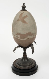 An Australian sterling silver mounted emu egg with carved kangaroo hunting scene, 19th century, stamped "STG. SIL.", ​​​​​​​24cm high