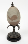 An Australian sterling silver mounted emu egg with carved kangaroo hunting scene, 19th century, stamped "STG. SIL.", ​​​​​​​24cm high - 2