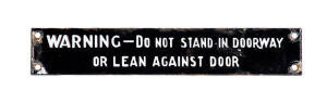 VR Sign: &ldquo;WARNING &ndash; DO NOT STAND IN DOORWAY OR LEAN AGAINST DOOR&rdquo;. A classic sign from Melbourne&rsquo;s suburban Tait trains. 4 x 22.5cm. Minor chipping around screw-holes but still very good condition.