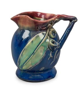 REMUED pottery vase with applied branch handle, gumnuts and gum leaf, glazed in early pink, green and blue colourway, incised "Remued 166", 13.5 cm high,14cm wide