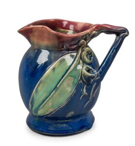 REMUED pottery vase with applied branch handle, gumnuts and gum leaf, glazed in early pink, green and blue colourway,  incised "Remued 166", 13.5 cm high,14cm wide