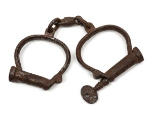 Convict handcuffs with original key, 19th century, 24cm wide