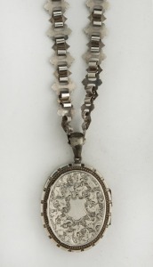 An antique sterling silver locket on original chain, 19th century