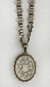An antique sterling silver locket on original chain, 19th century