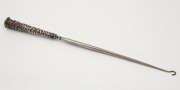 An antique silver boot hook with repousse decoration,&nbsp; ​​​​​​​33.5cm long