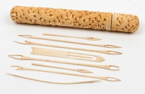 An antique Cantonese carved ivory needle case with fitted lid, containing eight ivory needles. 19th century, 16cm high